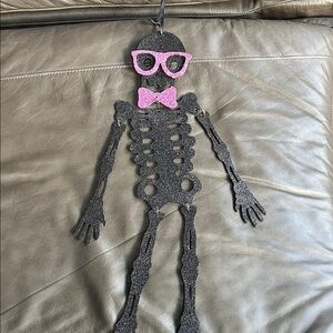 Black Skeleton Wall Hanging with Pink Accents